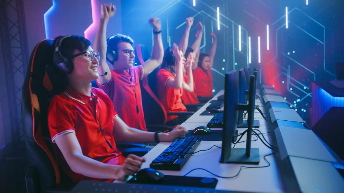 Esport Team of Pro Gamers Play in Video Game on a Championship A